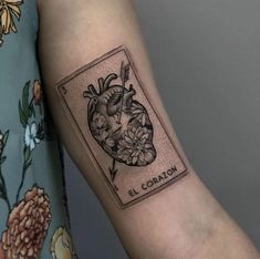 a woman's arm with a tattoo on it that says l'coran