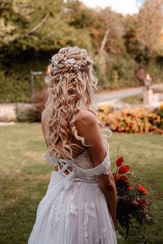 One boho hair idea is so gorgeous for any bride. You’ll love this look with its effortless vibe. Add it to your hairstyle collection. Wedding Bohemian Hair, Curly Down Wedding Hairstyles, Flower In Hair Wedding Hair Down, Boho Wedding Hair With Bangs, Boho Bridal Hair Flower Crown, Blonde Curly Wedding Hair, Wedding Hair Whimsical, Half Up Half Down Boho Wedding Hair, Wedding Hairstyles For Long Hair With Flowers