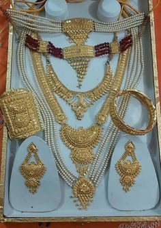 an assortment of gold jewelry in a box