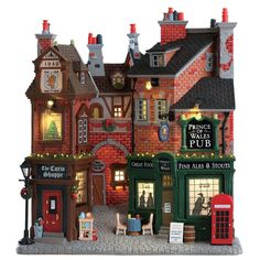 a miniature model of a pub in the shape of a building with lights on it