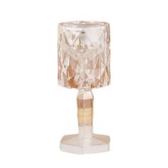 a clear glass candle holder on a white background with the light reflecting off of it's base