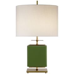 a green table lamp with a white shade on the base and a gold metal frame