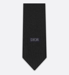 The tie is distinguished by the tonal Dior Oblique jacquard, first presented among the House's creations in 1969. Crafted in black silk, the tie will elegantly embellish any suit.. Timeless Black Suit And Tie Accessories For Semi-formal Occasions, Luxury Tailored Ties For Semi-formal Occasions, Timeless Black Suit And Tie Accessories, Luxury Silk Ties, Luxury Business Suit And Tie Accessories, Designer Workwear Ties, Elegant Black Ties For Semi-formal Occasions, Designer Suit And Tie Accessories For Workwear, Luxury Ties For Workwear