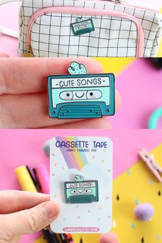 someone is holding up a cute cassette tape pin