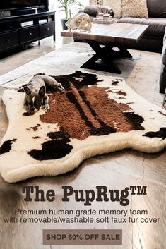 a dog laying on top of a brown and white rug