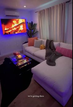 a living room filled with furniture and a flat screen tv mounted to the side of a wall