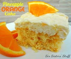 an orange cake with cream frosting and sliced oranges on a white plate next to the words, pineapple orange cake six sisters stuff