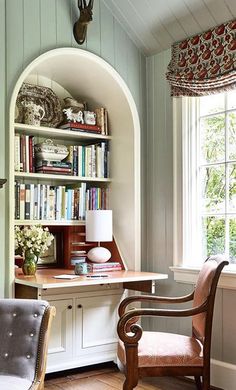 a room with a chair, desk and bookshelf