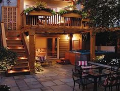 an image of a house at night with lights on the porch and stairs leading up to it