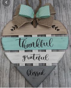 a wooden sign that says, thank grateful and closed with two bows on the top