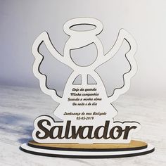 a wooden sign with an angel on it that says salvador and has the words in spanish