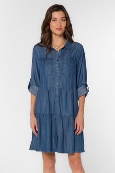 Our best selling tiered babydoll dress made in a lightweight denim-blue chambray Tencel™. It features a basic collar, button-up front, roll-tab sleeves, back yoke, front flap pockets, and a knee-length hem. Material: 100% Tencel™ Eco-Friendly Machine wash Color: 754 Calva Model is 5'9" and wearing a size S Imported Affordable Blue V-neck Denim Dress, Cheap Chambray Button-up Denim Dress, Cheap Chambray Denim Dress With Button Closure, Cheap Washed Blue Chambray Denim Dress, Long Sleeve Chambray Dress, Denim Cowgirl, Tiered Babydoll Dress, Cowgirl Dresses, Blue Denim Dress