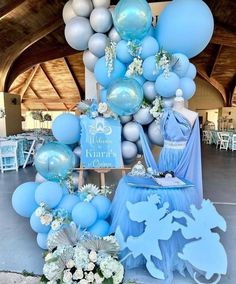 a blue and white balloon arch with balloons