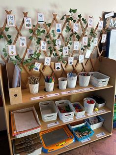 a wooden shelf filled with lots of different types of crafts and supplies next to a wall