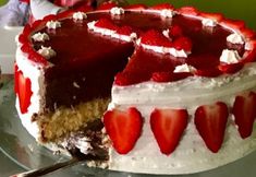 a cake with white frosting and strawberries on top