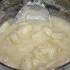 a silver pot filled with food on top of a stove