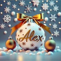 an ornament with the word alex on it and two christmas ornaments in front of snowflakes