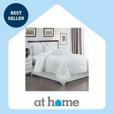 a bed with white comforter and pillows on top of it in front of a blue background