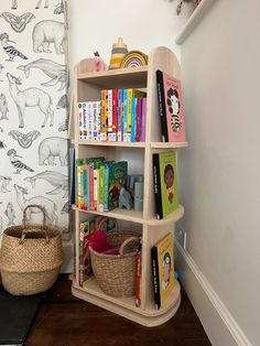 a book shelf with books and baskets on it