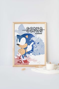 the sonic poster is next to a candle and some other items on a white table