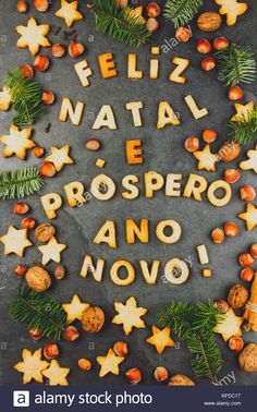 the words feliz natal e prospero and nourishment written in spanish surrounded by christmas decorations - stock image