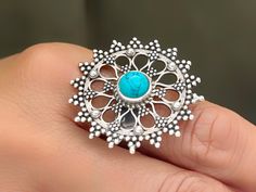 Turquoise Howlite statement ring in 92.5 Sterling Silver with adjustable size. In this ring Turquoise Howlite or Turquonite is set in the center of Silver flower made in 'Dana Work' (Hand dotting), making it exceptional piece of jewelry. It serves dual purpose as statement ring and spiritual ring Blue Howlite has the meaning and properties of enhancing daily happiness. It is a gemstone that contains very positive and bright energy. It will prevent you from being dominated by negative emotions. Interpreting things positive easily will increase your daily well-being. Our 92.5 hallmarked sterling silver jewelry is handmade by skilled artisans in Rajasthan, India using traditional,  centuries old jewelry making techniques.  All our jewelry pieces are delivered ready as gifts, packaged in a cot Adjustable Turquoise Flower Ring Gift, Turquoise Flower Ring Gift, Adjustable Bohemian Blue Flower Ring, Spiritual Ring, Jaipur Jewelry, Oxidized Silver Earrings, Oxidised Silver Jewelry, Blue Howlite, Ring Turquoise