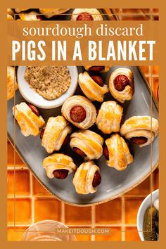 a plate with pigs in a blanket on it and the title says sourdough discard pigs in a blanket