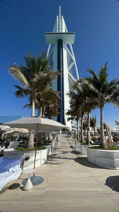 a tall tower with many palm trees around it