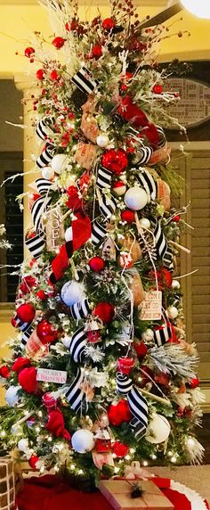 a decorated christmas tree with red, white and black decorations