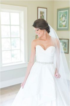 a woman in a white wedding dress and veil