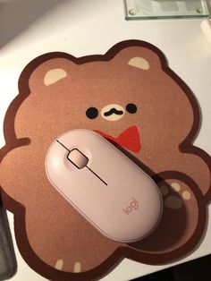 a mouse pad with a brown teddy bear on it