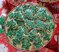 a plate full of decorated christmas tree cookies