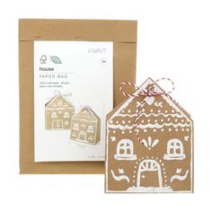 a brown paper bag with a ginger house on it next to a card and envelope