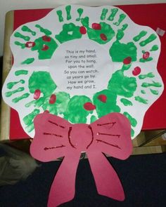 a paper plate with handprints on it and a pink ribbon around the rim