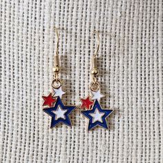 Red, White and Blue Stars Dangle Earrings ~ Great patriotic gift for the 4th of July New Handmade Earrings ~ Brighten Your Day with Dangles!   * Red, white and blue metal Stars *  Made with  18 K Gold Plated Ear Wires.  * All our earrings come with rubber backs. * Size: 1.5" from top of hook to bottom of earring. * Packing:- Earrings are nicely packed in a white embossed box with a pretty ribbon.   One stop shopping! Thanks for stopping. Visit our store to see more!  https://www.etsy.com/shop/LionsLair Packing Earrings, Patriotic Earrings, Red White And Blue Stars, Pretty Ribbon, Stop Shopping, Metal Stars, Patriotic Gifts, Blue Stars, Gift Handmade