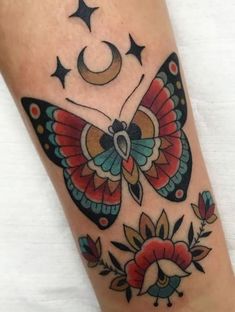 a colorful butterfly with stars and moon on it's back leg, done by me