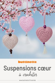 three crocheted hearts hanging from a tree branch with text overlay that reads, buttimette suspensions coeur a crochet