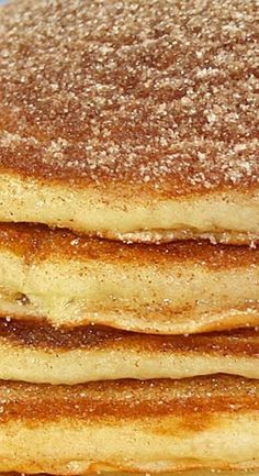 a stack of pancakes with powdered sugar on top