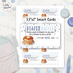 the baby's first birthday card has pancakes on it and is next to its diaper