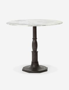 a white marble table with an iron base and round pedestal, on a grey background