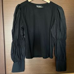 Perfect Condition. Chest: 19” Inches Across Length: 21” Inches Chic Black Blouse With Balloon Sleeves, Fitted Black Puff Sleeve Long Top, Chic Black Balloon Sleeve Blouse, Black Stretch Puff Sleeve Long Top, Casual Tops With Padded Bishop Sleeve Blouse, Black Stretch Puff Sleeve Top, Casual Long Sleeve Padded Blouse, Casual Padded Bishop Sleeve Blouse, Stretch Puff Sleeve Blouse For Work