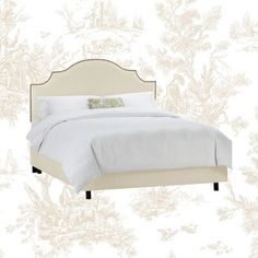 a white bed sitting next to a wall with a floral design on it's headboard