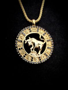 a gold necklace with a horse on it