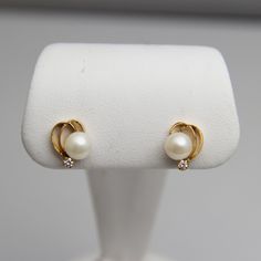 "For sale: (1) d762 Elegant 18k Yellow Gold Pearl Diamond Earrings PLEASE READ ENTIRE DESCRIPTION BEFORE PURCHASING Pre-owned item. Good condition. Please see pictures for details. Sold as is, as seen on pictures. These earrings contain one pearl and one diamond (round cut) each. They are elegantly designed and have been tested for authenticity. Specifics: 18k Yellow gold Diamonds: 0.10TCW (0.05CT/TCW EACH) Screw back Dimensions: 17.3 mm x 11.2 mm Total Weight: 4.1 grams Please be 100% sure of y Yellow Gold Pearl Earrings, Pearl Gold Earrings Indian, Gold Pearl Studs, Gold And Pearl Stud Earrings, Pearl Tops Earrings, Gold Pearl Earrings Studs, Elegant Yellow Gold Diamond Pearl Earrings, Gold Pearl Earrings Designs, Pearl Earrings Gold