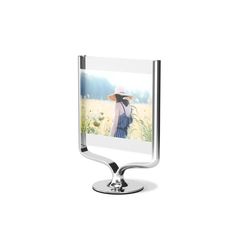 a metal stand with a glass frame on it and a woman wearing a hat in the background