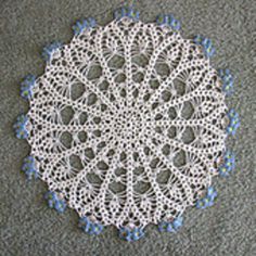 a crocheted doily is laying on the floor