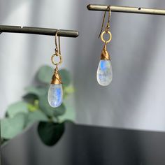 "Moonstone Earrings, Teardrop Earrings, June Birthstone, Earrings for Women, Gemstone Earrings, Gift for Girlfriend, Dangle Earrings, Gift for Her Sometimes less is more. Our polished Teardrop Moonstone earrings need no introduction. They are our \"clear\" favorite, no pun intended! Refreshingly light for wearing every day yet bold enough to take center stage for special occasions. When you want to dress up your outfit with the perfect balance of understated glamour, this earring is for you. The Moonstone Crystal Dangle Earrings, Everyday Moonstone Gemstone Earrings, Moonstone Dangle Earrings With Ear Wire, Moonstone Drop Earrings With Ear Wire, Dainty Teardrop Crystal Single Earring, Dainty Solitaire Teardrop Crystal Earring, Moonstone Drop Earrings For Gift, Moonstone Teardrop Gemstone Earrings, Teardrop Moonstone Gemstone Earrings