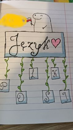 a child's hand writing on a notebook with the word fesyh in it