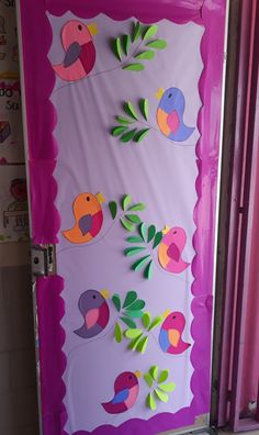 the door is decorated with colorful paper birds and leaves on purple background, along with pink bars