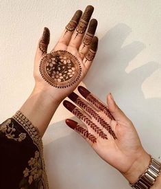 two hands with hendi designs on them